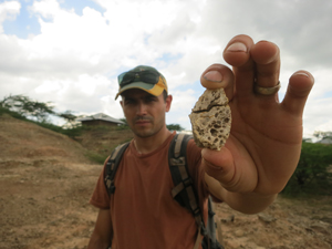 Tyler Faith with fossil remains of an early Miocene crocodile